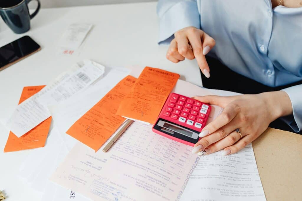 Photo by Photo By: Kaboompics.com: https://www.pexels.com/photo/person-holding-oink-calculator-7680744/