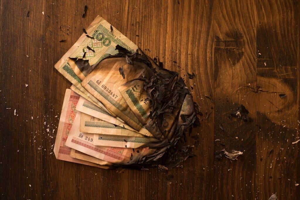 Photo by ArtHouse Studio: https://www.pexels.com/photo/stack-of-burnt-banknotes-4588678/