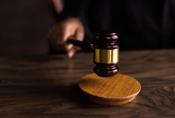 Photo by KATRIN BOLOVTSOVA: https://www.pexels.com/photo/brown-wooden-gavel-on-brown-wooden-table-6077326/